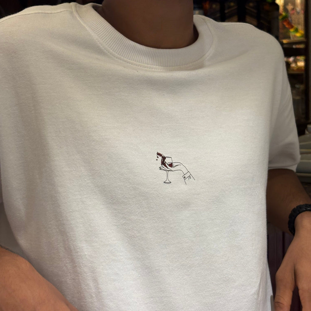 White t-shirt with a small black design on the chest