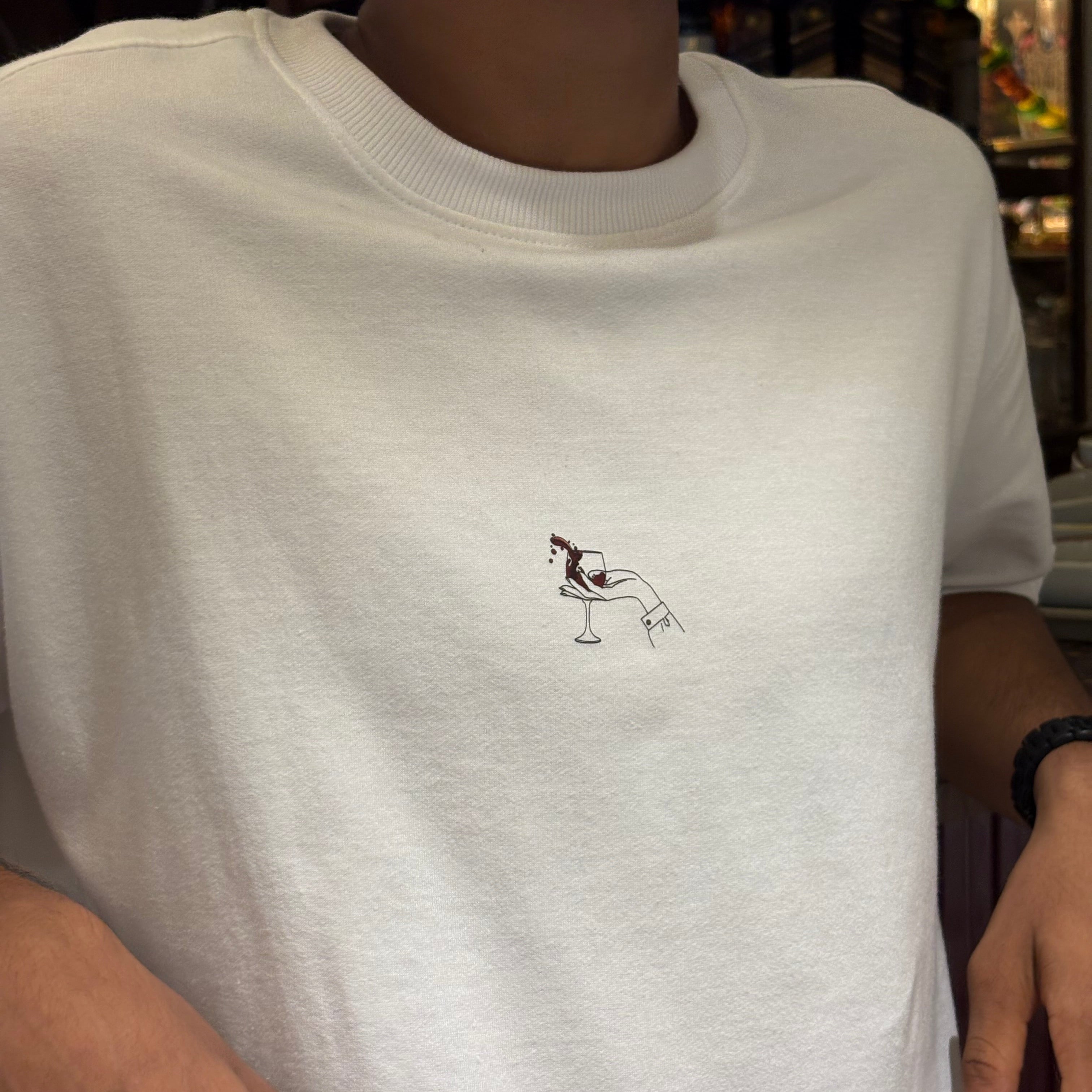 White t-shirt with a small black design on the chest